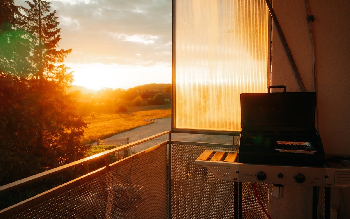 Barbacoa de sobremesa en uso en una terraza al atardecer